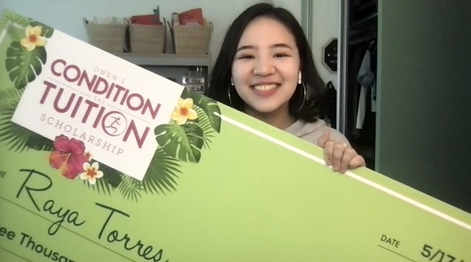 Torres in her dorm room with the Owen’s Condition For Tuition scholarship check. Photo credit Raya Torres. 